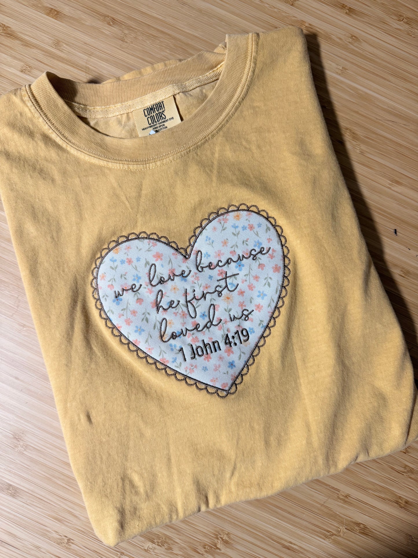 WE LOVE BECAUSE HE FIRST LOVED US EMBROIDERED ADULT SIZE (COLOR MUSTARD)